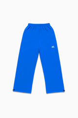 Jogging bleu électrique Cynique à coupe large, logo brodé blanc sur la cuisse, cordons de serrage aux chevilles. Coton épais 450 GSM, design unisexe oversize.