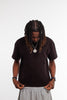 Model wearing Cynique Vanta Black Tee — boxy fit heavyweight T-shirt in 100% cotton with subtle chest logo, styled casually with gray sweatpants