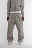 Front view of Cynique Basic Gray Jogger — oversized fit sweatpants in soft cotton with elastic waistband and embroidered logo, styled with white sneakers