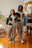 Le pull Monarch Knit de Cynique est présenté ici en look couple, soulignant son style oversize et unisexe. Design noir et blanc percutant avec portraits glitchés brodés, parfait pour un outfit streetwear coordonné. Look confortable et mode urbaine affirmée, photographié dans un décor vintage parisien.