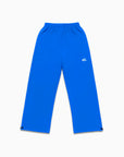 Jogging bleu électrique Cynique à coupe large, logo brodé blanc sur la cuisse, cordons de serrage aux chevilles. Coton épais 450 GSM, design unisexe oversize.