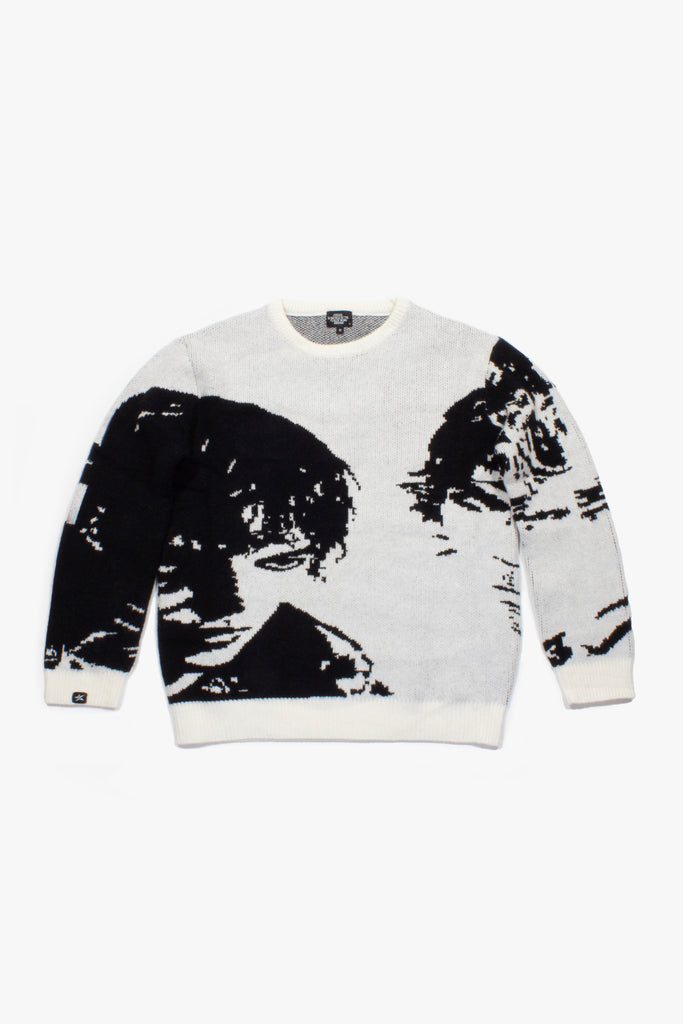 Flat lay of Cynique Monarch Knit sweater — black and white jacquard crewneck featuring abstract portrait design, made with cotton, wool, and cashmere blend